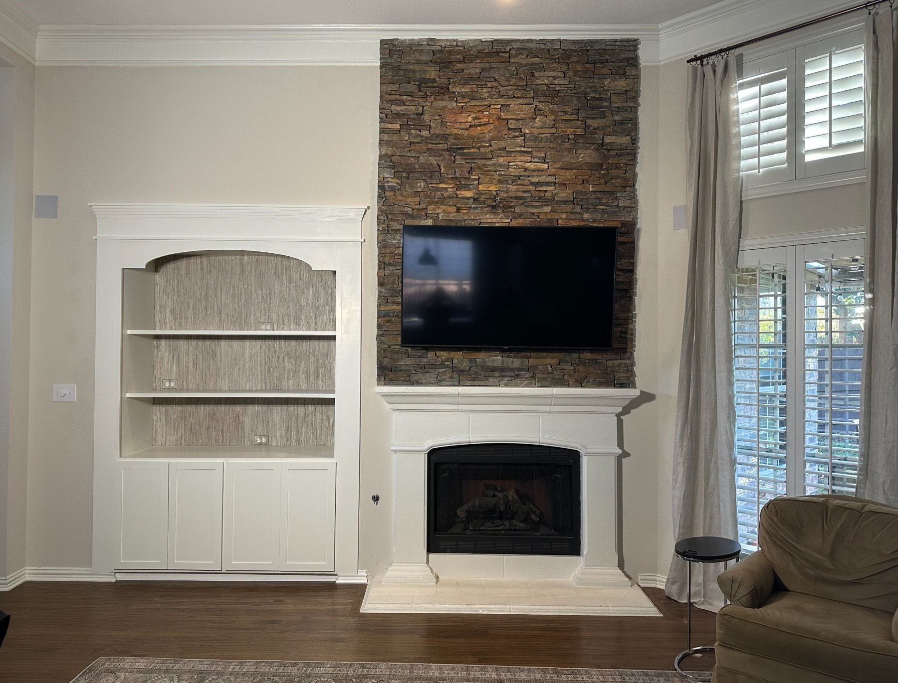 Finished custom built-in and stone fireplace wall